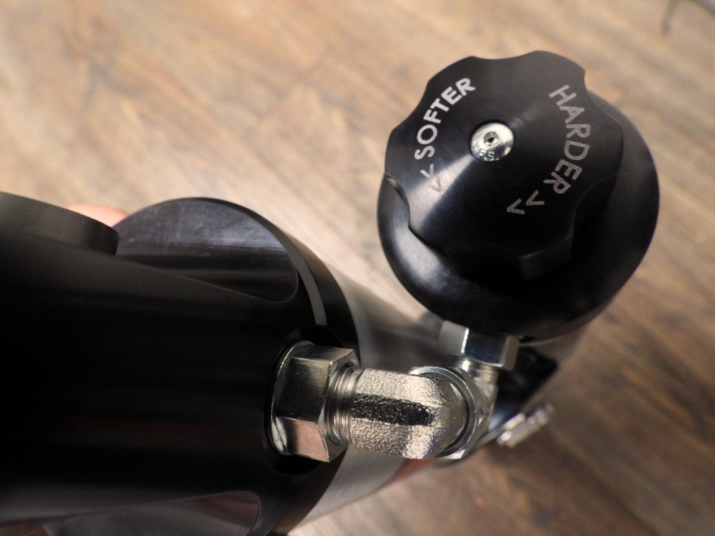 Compression adjuster knob on the optional Radflo RREV shock, softer and harder engraved into the dial