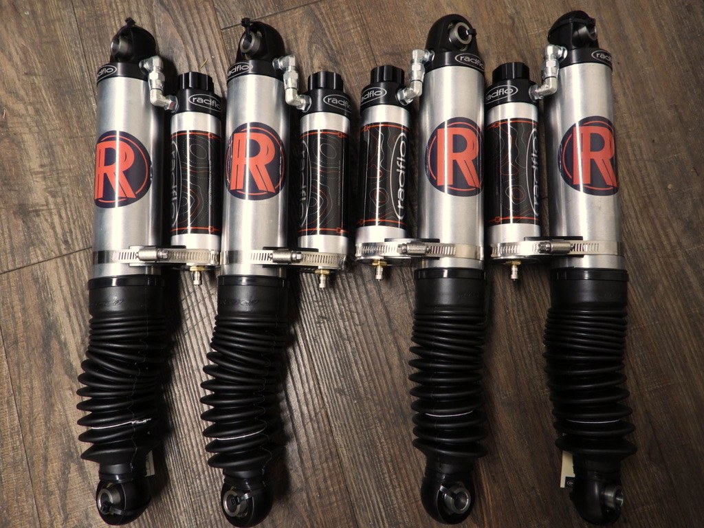 Set of four co-branded Radflo RREV remote-reservoir shocks laid out before installation