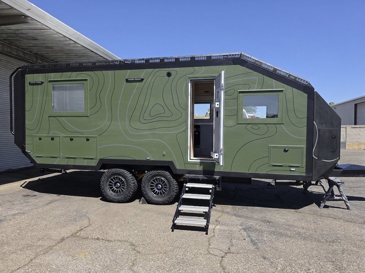 RREV expedition trailer in topographic green wrap with entry steps deployed