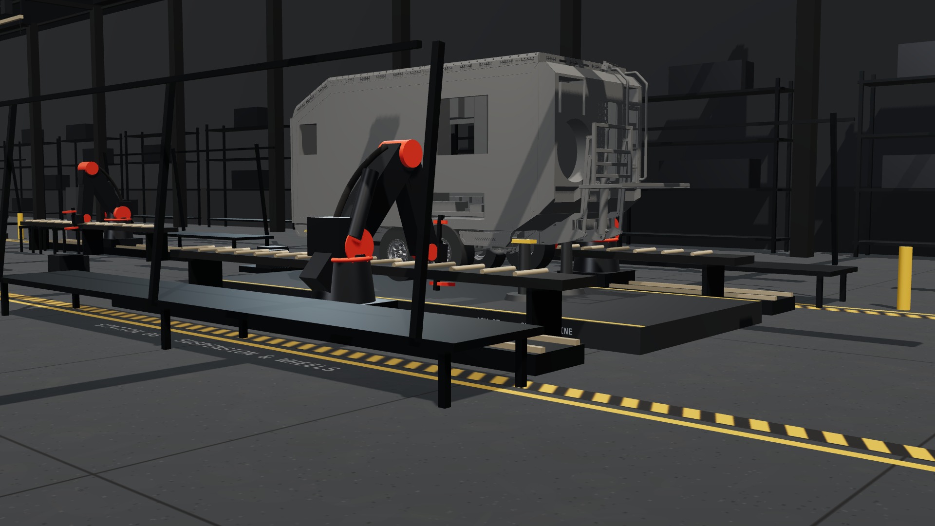 RREV Forge station six: trailing arms, shocks and hubs fitted from below, wheels spun onto the hubs, the trailer settling on its own air suspension for the first time.